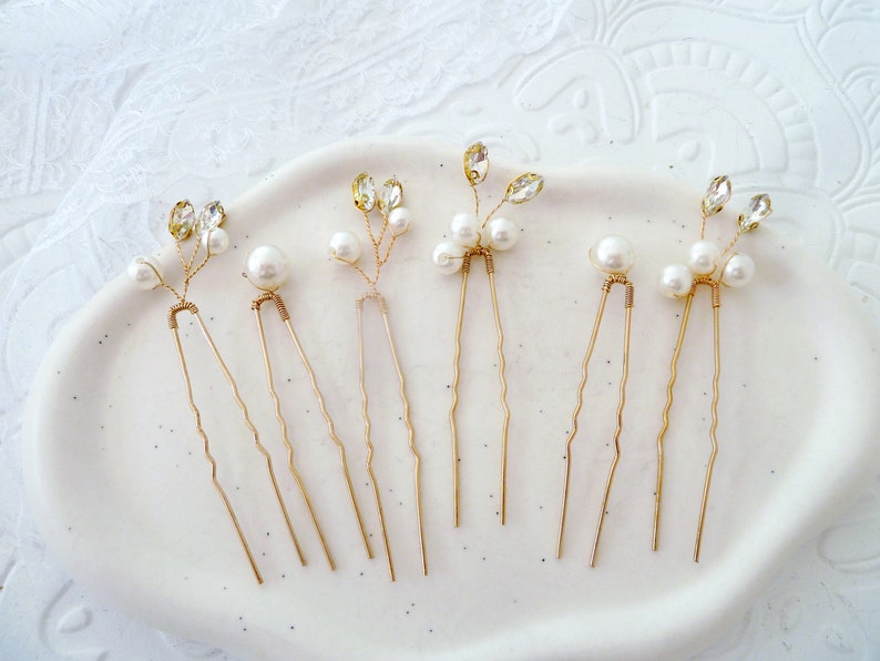 May include: Six gold hair pins with pearl and crystal accents. Each pin features a delicate branch design with small pearls and clear crystals.