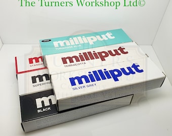 May include: A stack of five tubes of Milliput epoxy putty in various colors, including turquoise blue, terracotta, silver grey, superfine, and black. The tubes are labeled with the Milliput brand name and the color of the putty. The text "The Turners Workshop Ltd" is printed on the top of the stack.