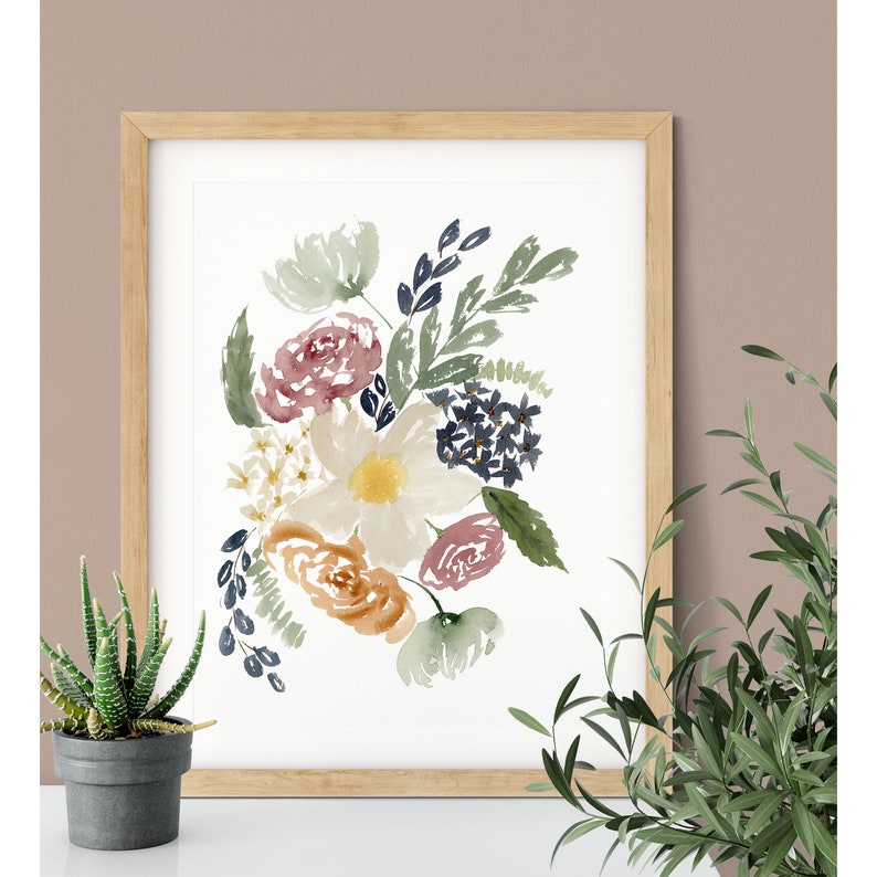 May include: Watercolor painting of a bouquet of flowers in shades of pink, orange, yellow, and blue. The flowers are arranged in a loose, organic style, and the background is white.