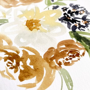 May include: Watercolor painting of flowers in shades of brown, yellow, and white, with accents of green and dark blue. The floral arrangement is painted on a white background, showcasing a delicate and artistic style.