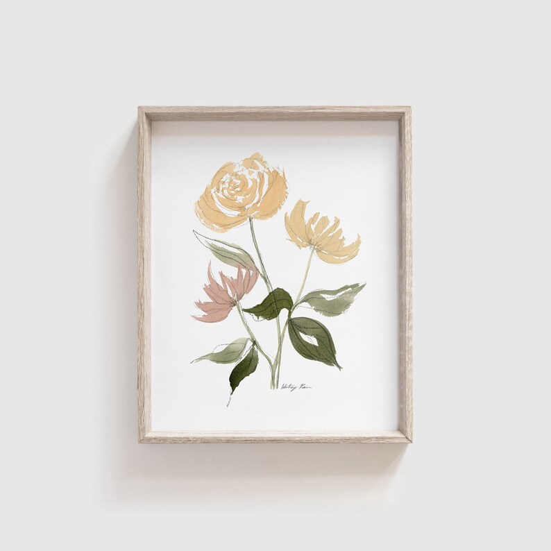 May include: A framed watercolor painting of yellow and peach flowers with green leaves. The painting is signed "Haley Rae".