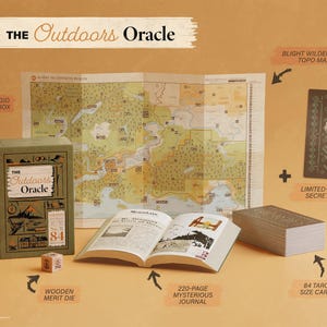 An oracle deck titled "The outdoors oracle" sits on display with it's core components including: A colorful topographical map, 84 tarot size cards, a mysterious looking 220-page journal, a wooden merit die, and limited edition bonus card.