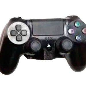 May include: A black PlayStation 4 controller with a silver faceplate and buttons. The controller has two analog sticks, a D-pad, and a variety of buttons.