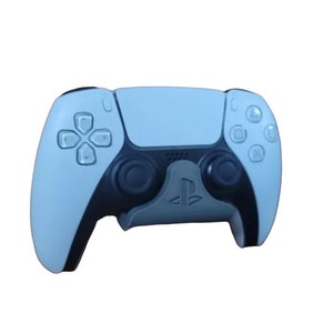 May include: A white and black PlayStation 5 controller with the PlayStation logo on the front.