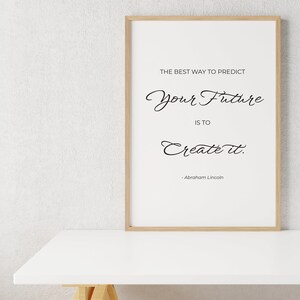 May include: A framed print with a white background and black text that reads "The best way to predict your future is to create it." - Abraham Lincoln.