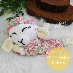 May include: A handmade crochet lamb with a white body and colorful pink, green, and orange accents. The lamb has closed eyes and is lying down. The image includes the text "PDF Crochet Pattern".