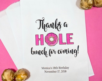 May include: White paper favor bags with a pink donut graphic and the text "Thanks a HOLE bunch for coming!"  Monica's 18th Birthday November 17, 2018.