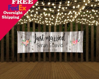 May include: A rectangular banner featuring a weathered gray wood plank background with floral accents on the left and right sides. The text reads Just married, Sarah & David, and September 22, 2021, in black script and sans-serif fonts.