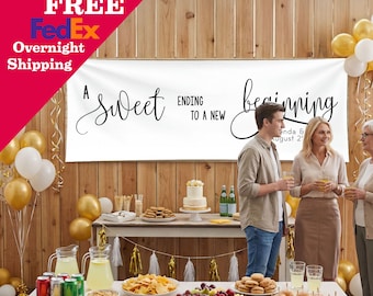 May include: A white horizontal banner featuring the black text A sweet ending to a new beginning with space for names and a date. The banner is displayed above a table set with food, drinks, and a cake, decorated with gold and white balloons.