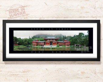 May include: A panoramic framed print of the Byodo-In Temple in Oahu, Hawaii. The red temple sits beside a pond with green trees and misty mountains in the background. The black mat features the text BYODO-IN TEMPLE and OAHU-HAWAII in white.