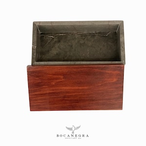 May include: A rectangular box with a wooden lid and a gray marble interior. The box is closed and the lid is slightly ajar. The box is made by Bocanegra Onyx Art Mx.
