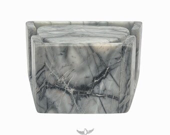 May include: Set of four gray marble coasters with a square shape and a beveled edge. The coasters are stacked on top of each other.