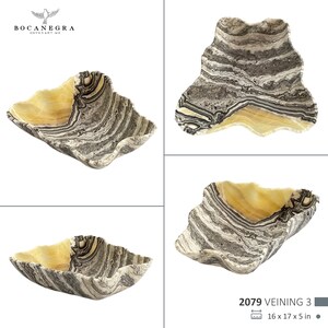 May include: A decorative onyx bowl with a unique, wavy shape. The bowl features a striking combination of colors, including creamy yellow and gray-black veining. The dimensions are 16 x 17 x 5 inches.