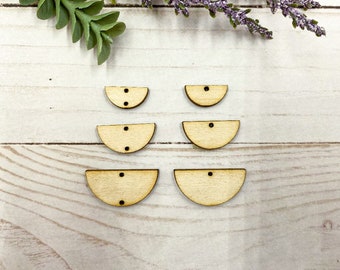 May include: Six unfinished wooden half-circle shapes with two holes each. The shapes are arranged in two rows of three.