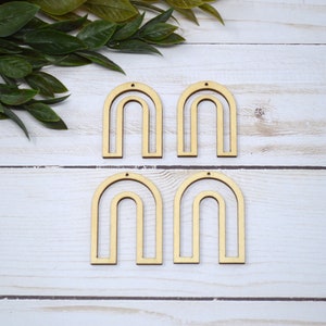 May include: Four unfinished wooden arch shapes with holes for hanging. The arches are double layered and are perfect for crafting.