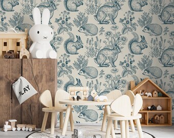 May include: A light beige wallpaper with a repeating pattern of blue squirrels, rabbits, and hedgehogs. The animals are surrounded by blue flowers and leaves. The wallpaper is in a child's room with a wooden table and chairs.