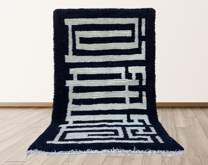 Handmade Moroccan Wool Area Rug with a labyrinthine design.