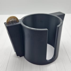 May include: A trio of cream-glazed ceramic mugs with a speckled finish. Each mug is adorned with a hand-painted design: a blue and green leaf, a yellow flower, and a red berry. The mugs have a simple, modern design.