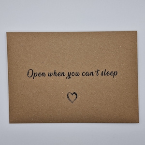 K&ouml;nnte beinhalten: Ein brauner Papierumschlag mit dem Text "Open when you can't sleep" und einem kleinen gezeichneten Herzen.