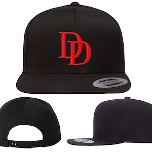 May include: Black and red baseball cap with the letters "DD" embroidered on the front in red.