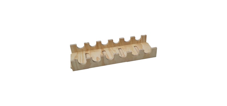 May include: A wooden wine bottle holder with six slots. The holder is made of light brown wood and has a natural finish.
