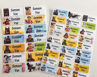 May include: A sheet of colorful rectangular name labels with various superhero and cartoon characters. The labels are white with black text that reads "Samson Van".