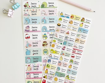 May include: A set of colorful name labels featuring a variety of cute cartoon characters. The labels are rectangular and have a white background with a colorful border. The name "Jessica Smith" is printed on each label.