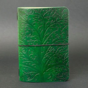 Może przedstawiać: Zielony skórzany notes z wytłoczonym wzorem drzewa na okładce. Notes ma czarną gumkę.