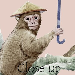 May include: A watercolor illustration of a brown monkey wearing a tan conical hat, holding a blue umbrella handle while sitting among large green leaves. The text "Close up" is written in black at the bottom of the image.