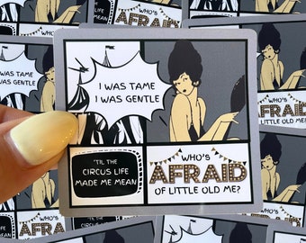 May include: A set of colorful stickers featuring a vintage illustration of a woman in a flapper dress. The stickers have a comic book style design with speech bubbles that say "I was tame, I was gentle" and "'Til the circus life made me mean." The main sticker features the text "Who's afraid of little old me?"