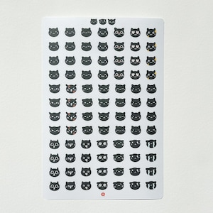 May include: A sheet of black cat stickers with various facial expressions, including happy, sad, angry, and surprised. The stickers are on a white background.