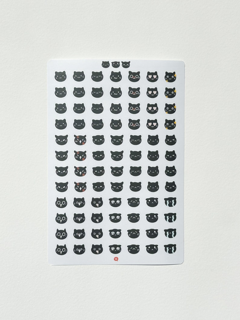 May include: A sheet of black cat stickers with various facial expressions, including happy, sad, angry, and surprised. The stickers are on a white background.