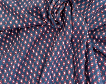 Viscose print, small pattern in red and white on a dark blue background