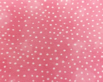 Cotton jersey dots in white on a pink Oeko-Tex background, 145 cm wide