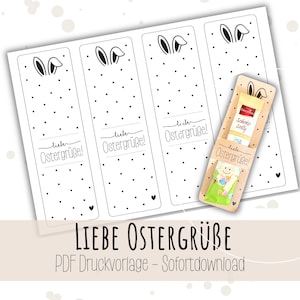Può includere: Un set di segnalibri stampabili a tema pasquale e un piccolo portaregalo. I segnalibri presentano orecchie di coniglio, pois e il testo "Liebe Ostergrüße!". Il portaregalo contiene due piccoli dolcetti.