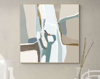 May include: Abstract art print with geometric shapes in shades of blue, brown, and white. The print is framed and hanging on a wall in a living room setting.