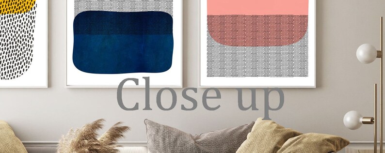 May include: Three framed abstract art prints. One features a yellow and black design, another a blue shape, and the third a pink and gray design. The text "Close up" is visible in the image.