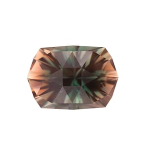 May include: A faceted gemstone with a rectangular shape and a mix of colors, including peach, green, and brown. The gem is set against a white background, highlighting its intricate cuts and polished surfaces. This gemstone is suitable for jewelry making.