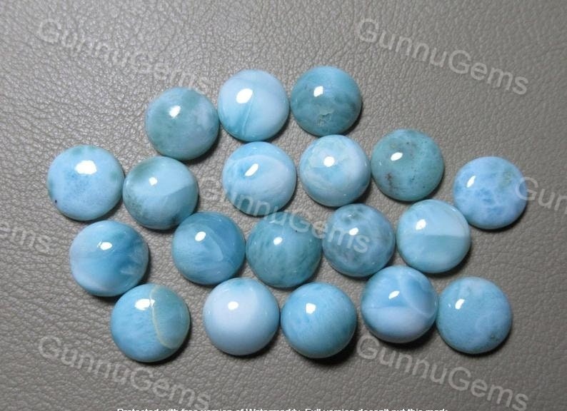 May include: A collection of 18 round, light blue cabochon gemstones with a marbled pattern.
