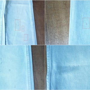 May include: Close-up of light blue denim fabric. The fabric has a textured appearance with subtle variations in color. There are several small, light-colored spots and marks scattered across the surface of the denim. The image is well-lit, highlighting the details of the material.