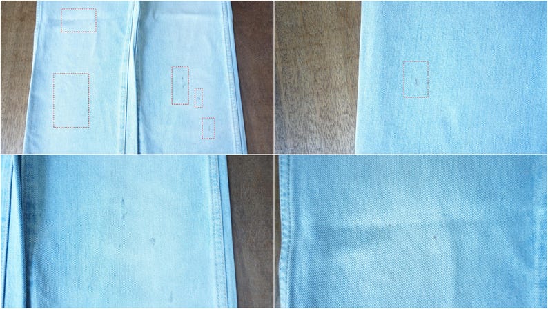 May include: Close-up of light blue denim fabric. The fabric has a textured appearance with subtle variations in color. There are several small, light-colored spots and marks scattered across the surface of the denim. The image is well-lit, highlighting the details of the material.