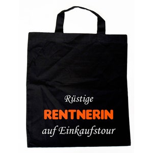 Könnte beinhalten: Schwarze Einkaufstasche mit weißem Text, der "Rüstige Rentnerin auf Einkaufstour" lautet, wobei das Wort "Rentnerin" orange ist.