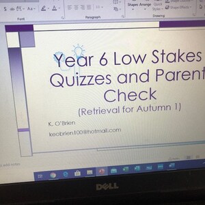 May include: A computer screen displaying a PowerPoint presentation titled "Year 6 Low Stakes Quizzes and Parent Check (Retrieval for Autumn 1)". The presentation includes the presenter's name, K. O'Brien, and email address, keobrien100@hotmail.com.