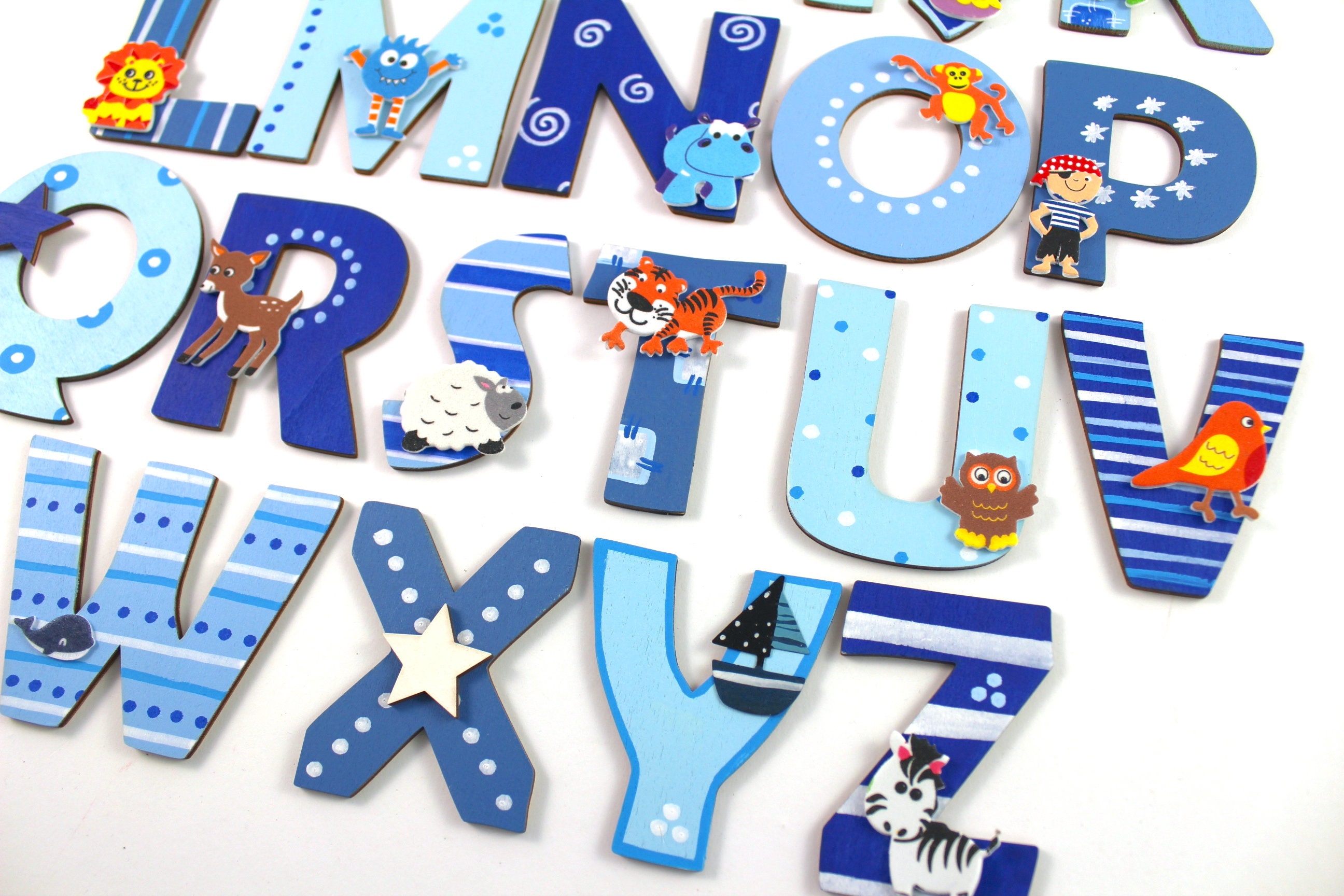 Wooden letter nursery door with matching motifs Etsy