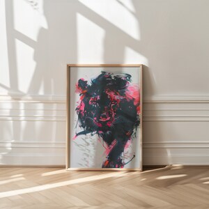 May include: A framed abstract painting of a lion's head in black, pink, and white. The painting is in a gold frame and is hanging on a white wall.