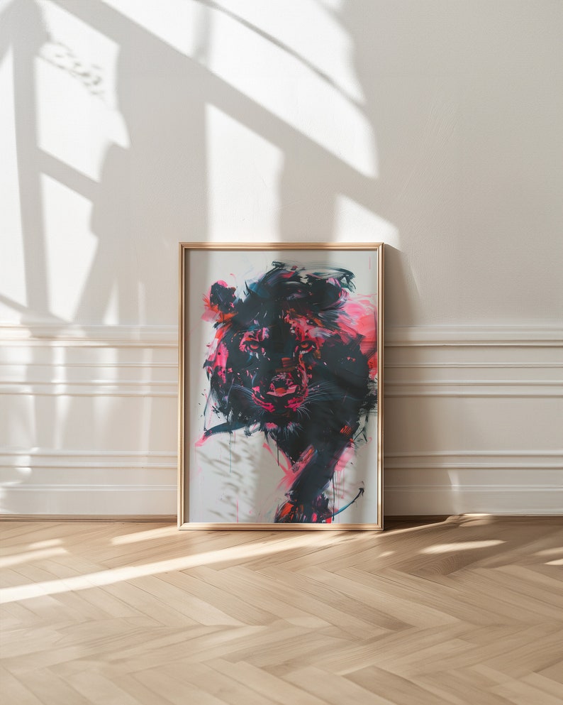 May include: A framed abstract painting of a lion's head in black, pink, and white. The painting is in a gold frame and is hanging on a white wall.