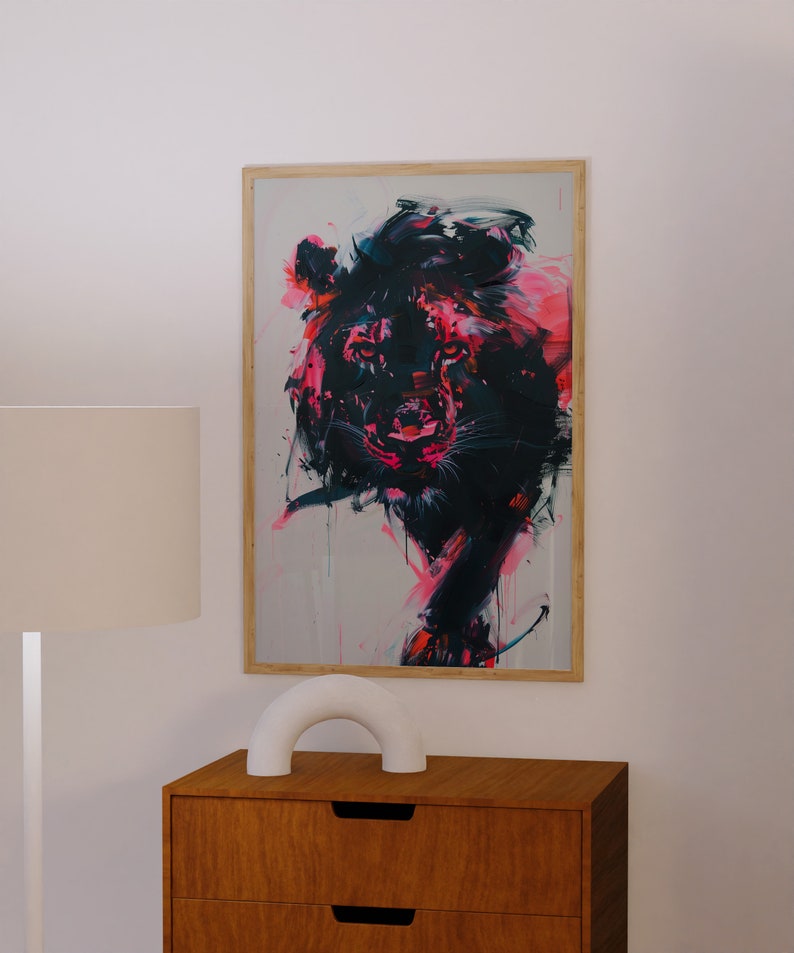 May include: A framed abstract painting of a lion's head in shades of pink, black, and white. The lion's face is rendered in a bold, expressive style with visible brushstrokes.