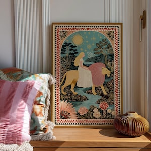 May include: A framed art print depicts a woman riding a lion through a landscape. The artwork features a woman with long blonde hair in a white dress, riding a golden lion with a pink mane. The background includes a river, trees, flowers, and a sun.