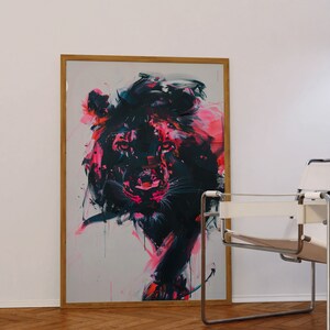 May include: A framed abstract painting of a lion's head in black, pink, and white. The lion's face is in focus, with the rest of the painting blurred.