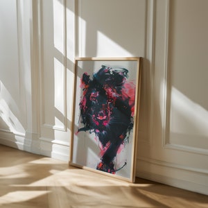 May include: A framed abstract painting of a lion with pink, black, and white paint. The lion is facing forward with its mouth slightly open. The painting is in a wooden frame.